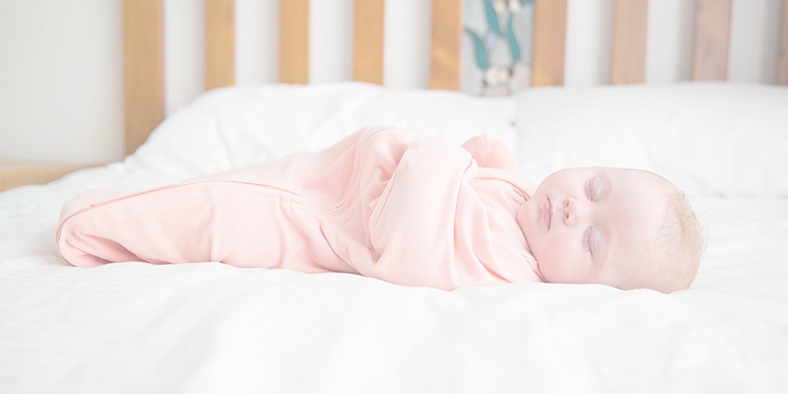 Baby sleeping bag for transitioning to free arms when babies show signs of starting to roll