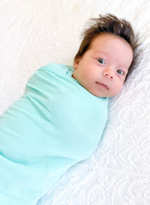 Koala Hugs newborn swaddle wrap gently cocoons baby's arms to help calm the startle reflex.